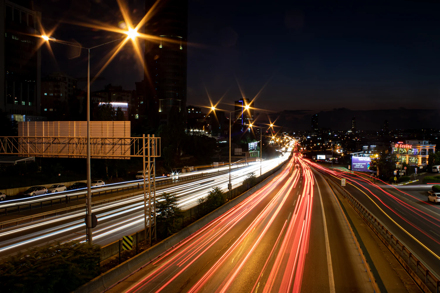 Avenida urbana venezolana de noche con tráfico en larga exposición
